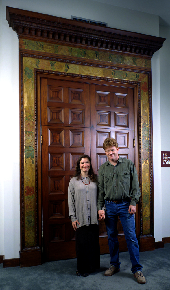 Tim Holton and STephanie McCoy in front of carved Mathews door