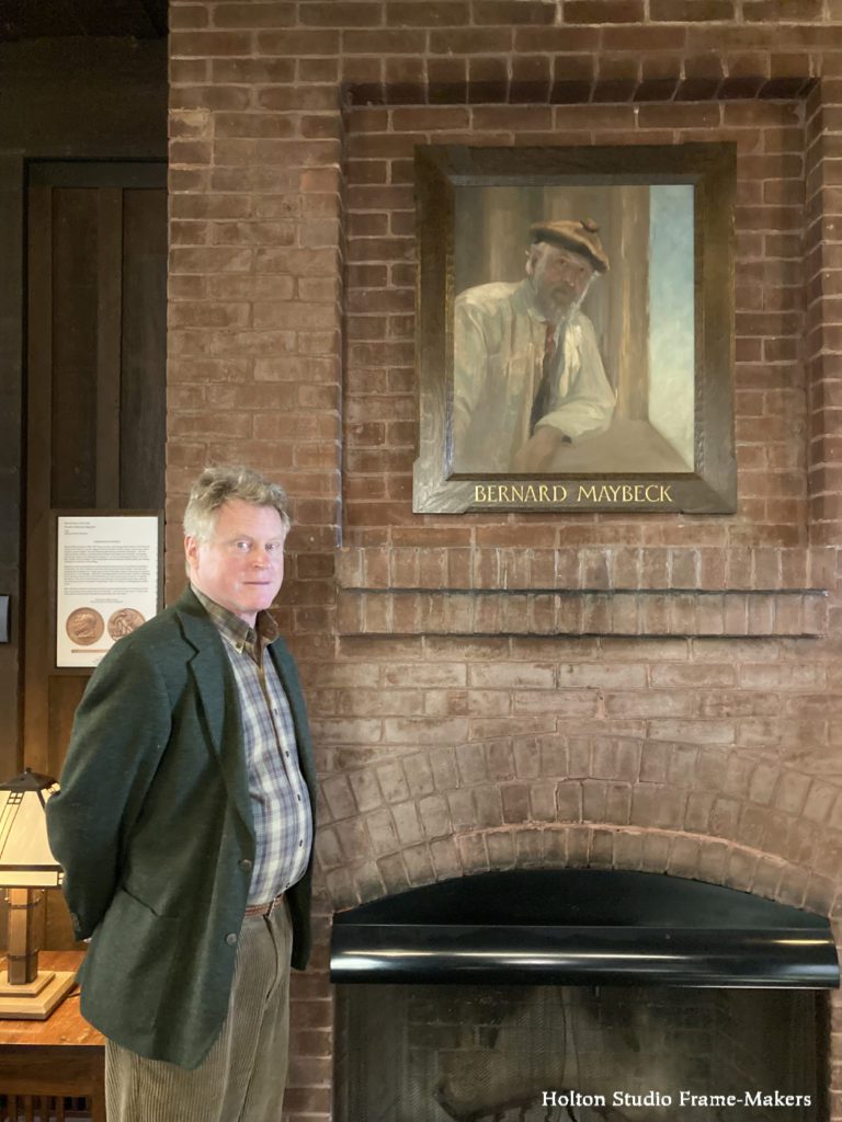 Tim Holton with framed painting of Bernard Maybeck