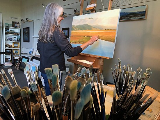 Christin Coy painting in her studio